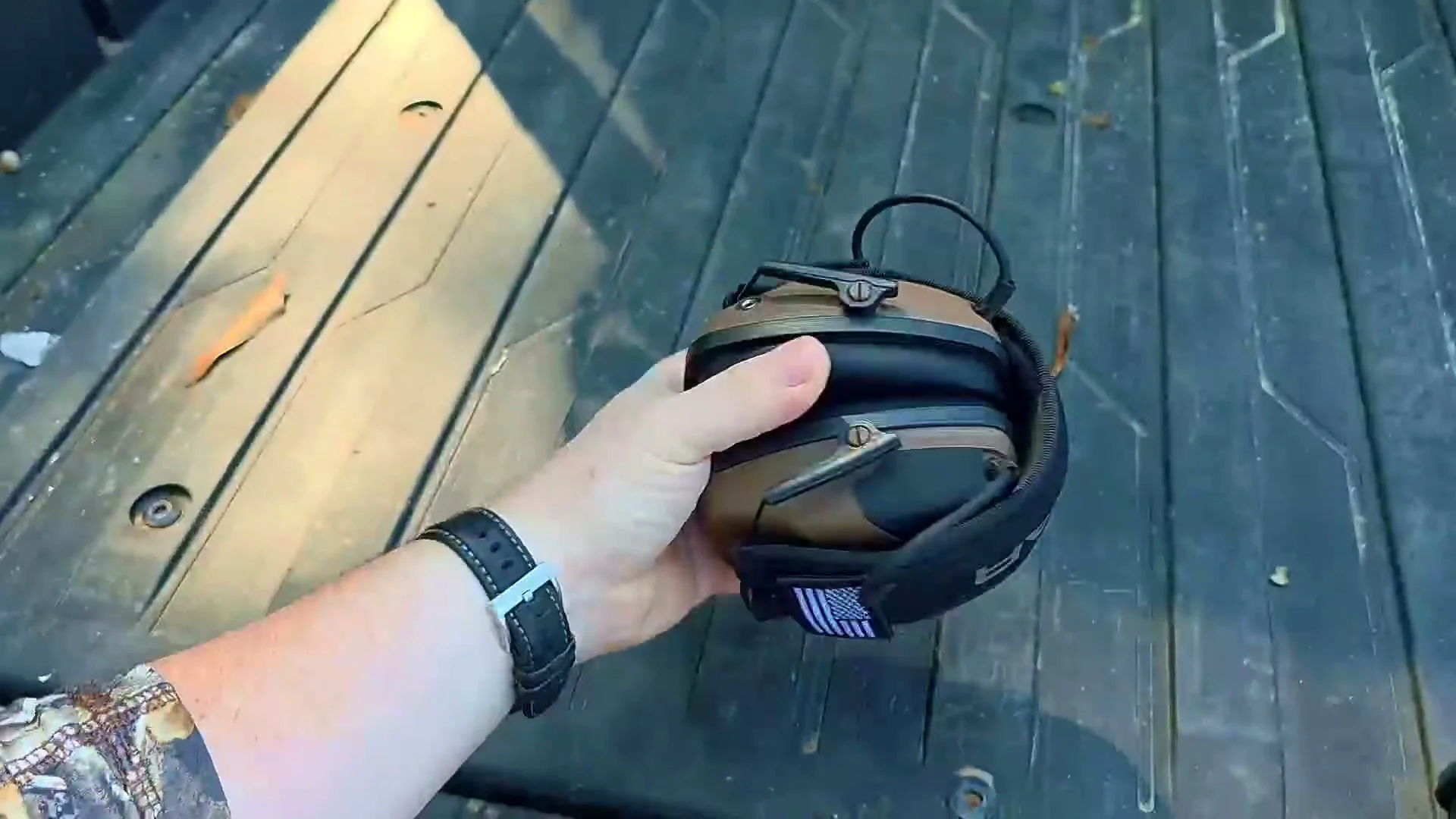 Electronic shooting earmuffs on a range bench